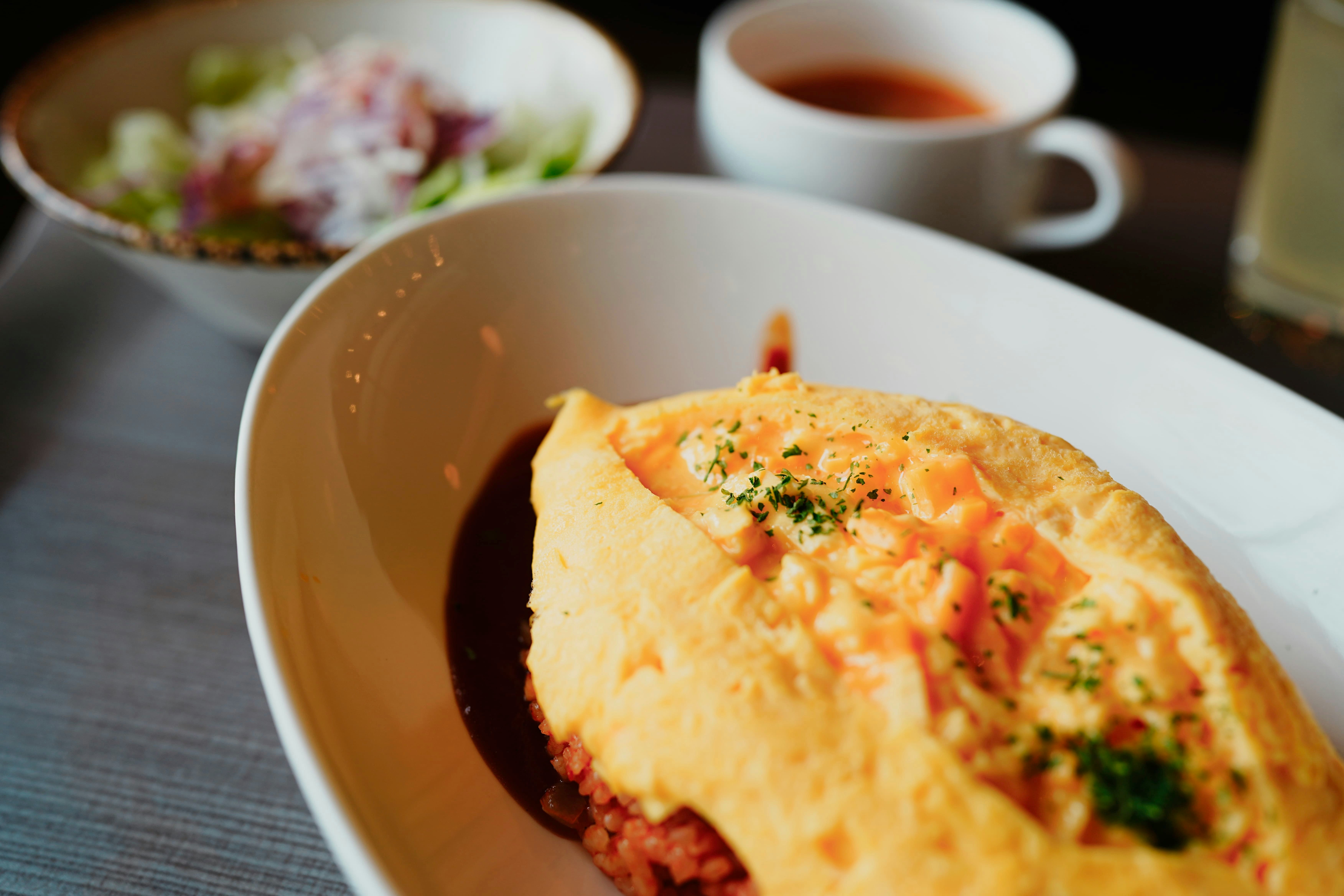 Toro-toro omurice on a plate with demi-glace