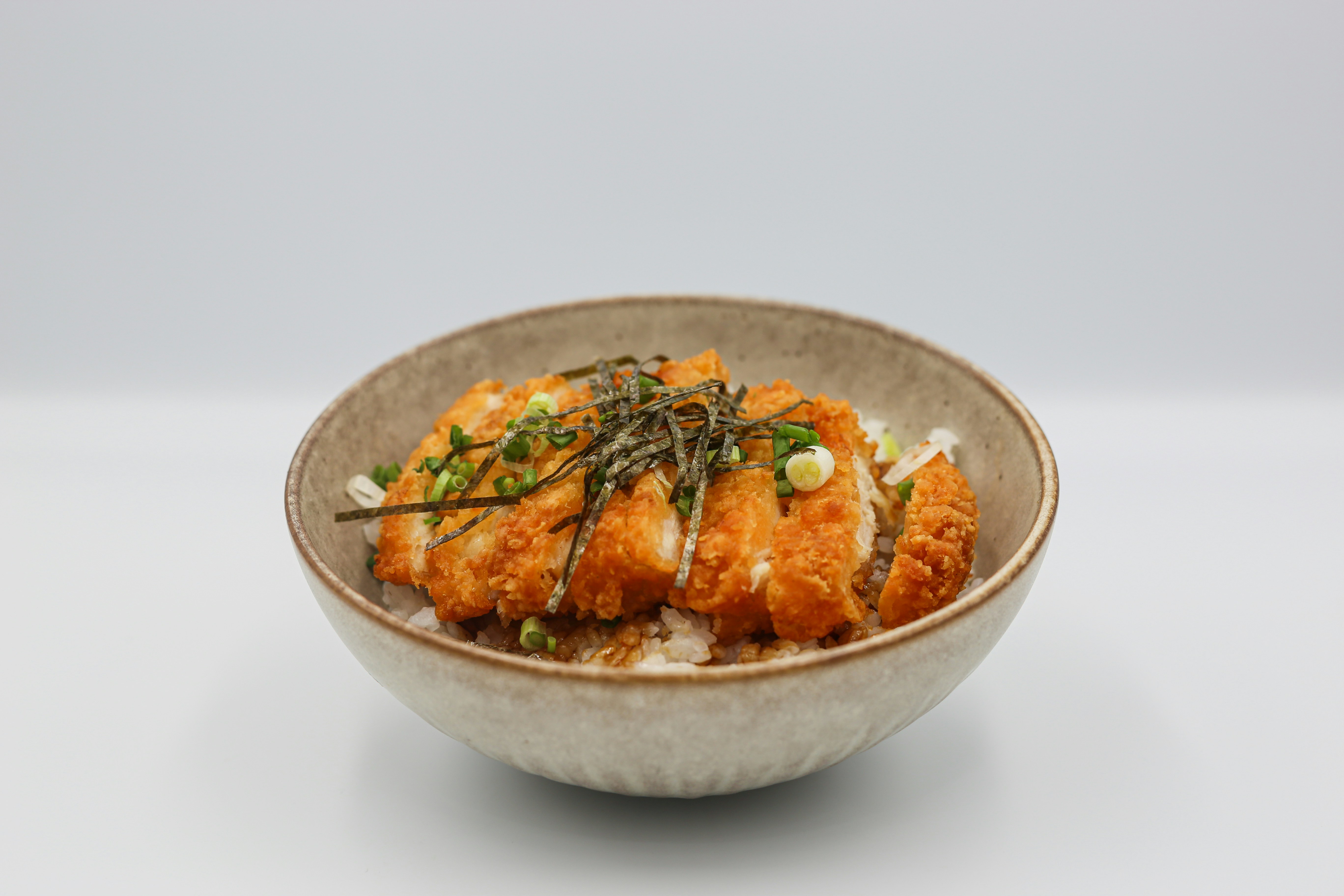 Katsu curry with rice and seaweed in a bowl
